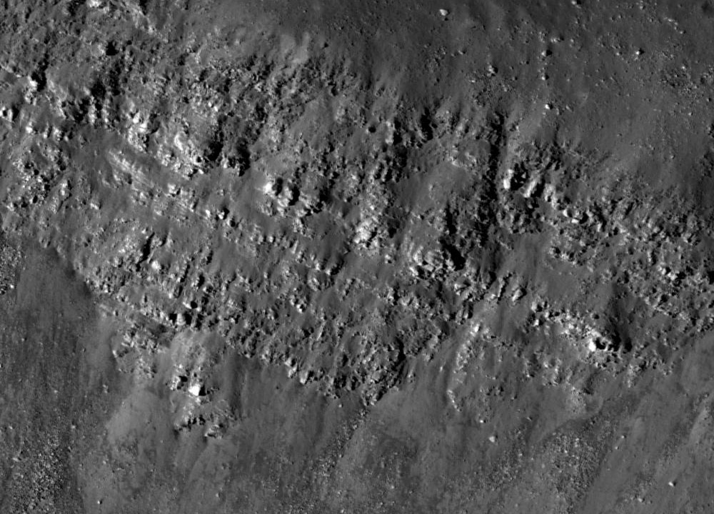 Llanura mareal con flujos basálticos oscuros y canales de lava en Oceanus Procellarum